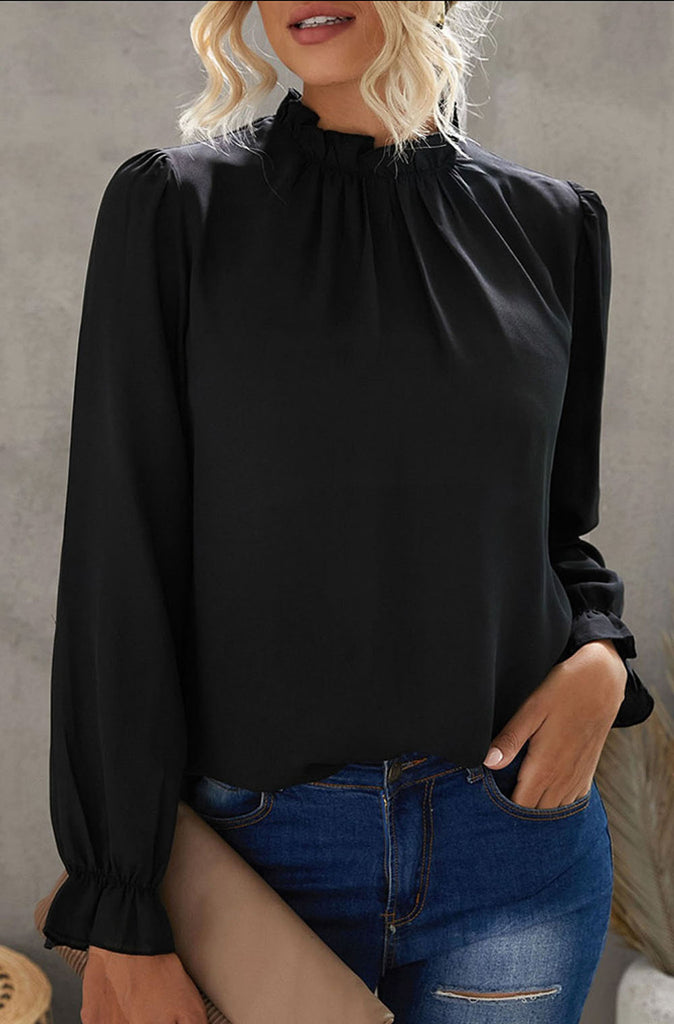 Blonde woman wearing the Sophia Frill Sleeve mock neck blouse from Stella by Stacia